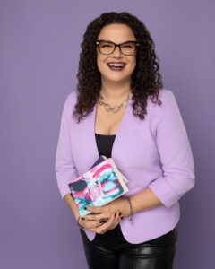 Marisol Cruz lawyer and author holding her published novels